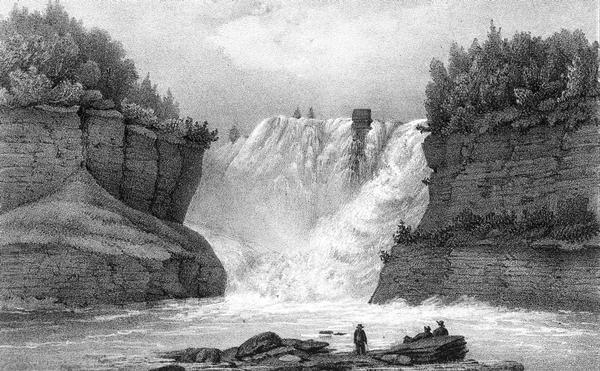 Kakabeka Falls, with men in the foreground facing the falls.