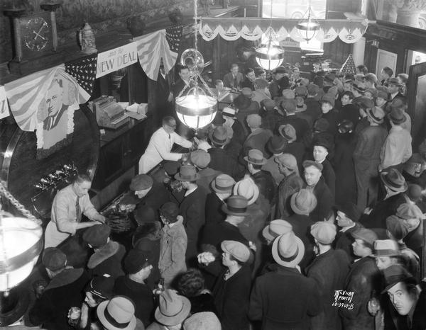 Overhead view of bar and crowd in Fauerbach Brewing Co. tavern at 651 Williamson Street, celebrating the end of Prohibition.