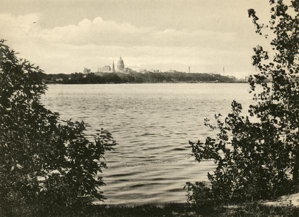 View of the Wisconsin State Capitol from Lake Monona prior to the building of the State Office Building at 1 West Wilson Street in 1923.