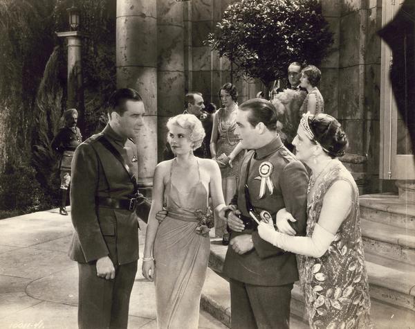 Production still from "Hell's Angels," the Howard Hughes 1930 film, which launched the career of 18-year-old Jean Harlow. She is shown here with co-stars Ben Lyon and James Hall, wearing a revealing and controversial dress.  The photograph makes clear why Harlow was destined for Hollywood stardom.
