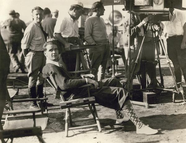 Howard Hughes on the set of "Sky Devils," a comedy about World War I aviation that starred Spencer Tracy. Hughes reused many of the airplanes he obtained for the 1930 production of "Hell's Angels."  Here he is on location superintending the shooting of the air scenes.