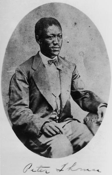 Seated portrait of Peter D. Thomas (1847-1925) of Racine. Thomas was an escaped slave who joined the 15th Wisconsin Regiment during its service in Tennessee. Thomas served Lt. Charles B. Nelson of Co. G at Chickamauga and other battles, then enlisted in a USCT regiment. Later he followed Wisconsin troops back to Beloit and attended school there. In time he made his home in Racine and was elected Racine County coroner.