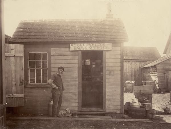 Post office with man and dog. This was the Louisville Post Office, west of Downsville in the town of Dunn.