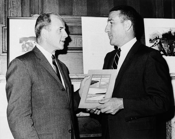 Secretary Stewart Udall presenting Secretary Gaylord Nelson with the first copy of the Interior Department task force report on the proposed Apostle Islands National Lakeshore.