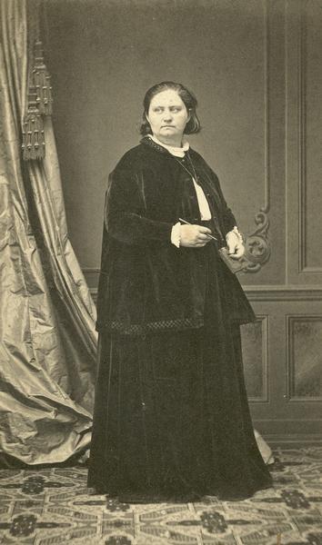 Formal studio portrait of Mathilde Franziska Anneke wearing dark dress and coat.