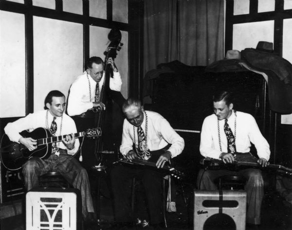 "Hawaiian Group," a four-piece country band made up of (left to right): Martin Angus, Al Flansberg, Jack Pennywell, and George Gilbertson.  Their instruments include lap steel guitars, upright bass, and guitar.