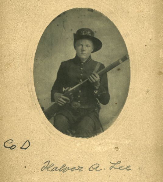 Portrait of Halvor A. Lee of the 15th Wisconsin Volunteer Infantry, Company D, holding a gun.