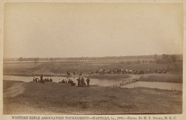 Participants, spectators, and the competition grounds of the Western Rifle Association Tournament.