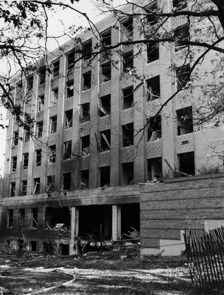 Exterior view of the east wing of Sterling Hall showing damage in the aftermath of the bombing.

Unfortunately, despite an attempt to detonate the bomb when the building was vacant, a physics researcher conducting research unrelated to Army Math Research Center, was killed in the explosion. The sobering impact of Robert Fassnacht's death brought a sudden halt to the violence to which anti-war protesters and police had resorted.
