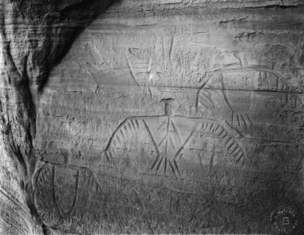Thunderbird petroglyphs carved on rock face at Twin Bluffs.