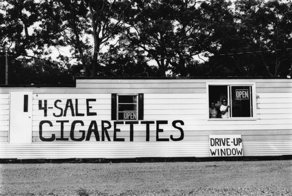 Winnebago Enterprises trailer, advertising drive-up cigarette sales.