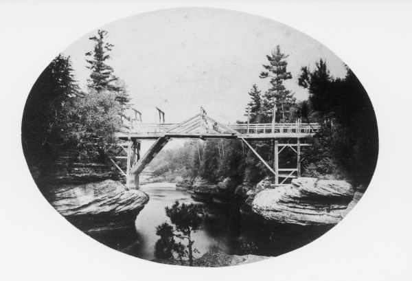 View of the first bridge to span the Wisconsin River, built by Schuyler Gates. It was washed away in 1866.