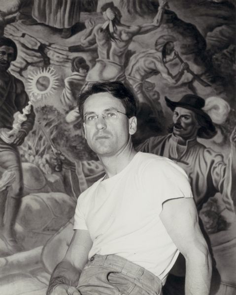 Portrait of artist William Ashby McCloy (1913-2000), in front his three part mural depicting the history of Wisconsin.  He was born in Maryland and spent most of his childhood in China, returning to the United States at age 13.  He received a BA in Art at the State University of Iowa, earning a scholarship awarded to that member of the senior class "giving the most promise of attainment in a learned career."  He studied painting, printmaking, and sculpture, and earned an MA in psychology in 1936.  In 1939/1941 he began to teach at the University of Wisconsin and came to know the school's artist in residence, American regionalist painter John Steuart Curry.  After working as Curry's mural assistant, McCloy served as a clinical psychologist in the Army during World War II.

McCloy returned to the State University of Iowa, where he earned an MFA in 1949 and a PhD in Art History in 1958.  McCloy served as Director of the School of Art at the University of Manitoba from 1950 to 1954 and afterward became Chairman of the Art Department at Connecticut College, from which he retired in 1978.  His paintings and sculpture were exhibited throughout the United States and Canada and won numerous awards.