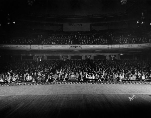 View from the stage of a full audience of costumed Halloween party-goers in the auditorium at the Orpheum Theatre, 216 State Street.