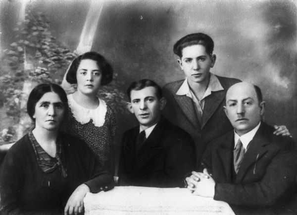 Group portrait in front of a painted backdrop of the Goldberg family (from left): Sara (mother), Rosa Goldberg Katz, Uncle Hirsch, Moishe (brother), Abraham (father); Lodz, Poland.