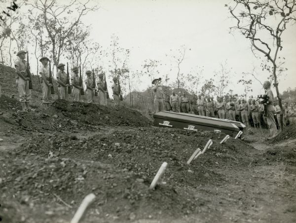 "Taps" is played at the Darnton-Fahuestock funeral; Bomana Military Cemetery, Port Moresby, New Guinea.