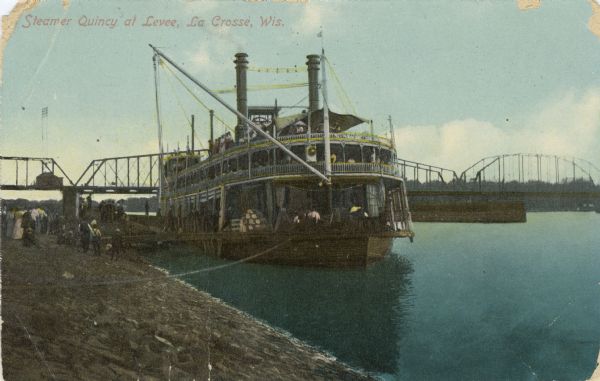 The sidewheel packet, <i>Quincy</i>, tied up at the levee. Bridge in background. Later named <i>J.S.</i> Caption reads: "Steamer <i>Quincy</i> at Levee, La Crosse, Wis."