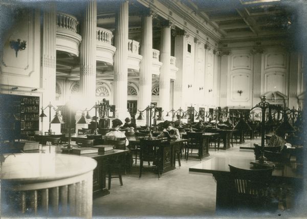 University of Wisconsin students (primarily women) studying in the Historical Society Library Reading Room. On the left is the Visitors Gallery.