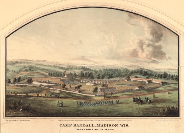 Camp Randall: Lithograph of Camp Randall, where the majority of Wisconsin's soldiers were trained and mustered into the Union Army. This view, which was taken from Bascom Hill looking southwest, shows a railroad track in the foreground which followed the route along University Avenue still used today. Inside the fenced enclosure barracks, prison yard and guard house, officers quarters, stables, and (the large building on the right) a hospital.