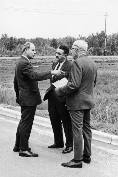 Senator Gaylord Nelson, William Hansen, and University of Wisconsin-Stevens Point president Lee Dreyfus converse at the Water Quality Lab that is to be built on the campus. Hanson, a former president of the University was considered to be the "father" of its Conservation school.
