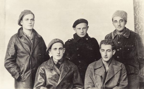 Five Wisconsin men who fought in the Abraham Lincoln Brigade in the Spanish Civil War. This was in Albacete, Spain. From left to right standing are: Fred Palmer, Harry Lichter, and Ray Disch; and sitting are: John Cockson and Clarence Kailin.