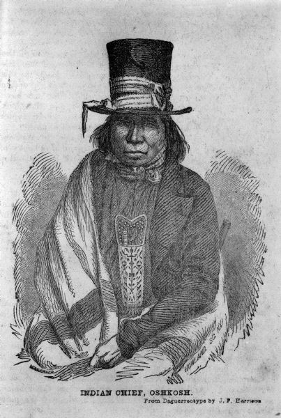 Drawing of Chief Oshkosh rendered from a daguerreotype by J.F. Harrison. He is wearing a top hat wrapped with a ribbon. Also a suitcoat, bowtie, beaded neckpouch and a blanket wrapped around his shoulders.