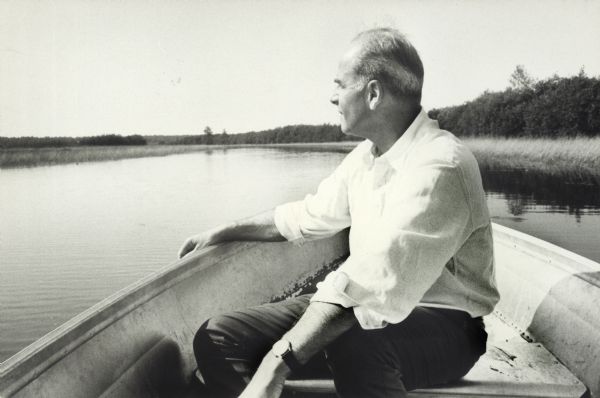 Nelson sits in a canoe and looks out over the water around the Apostle Islands.