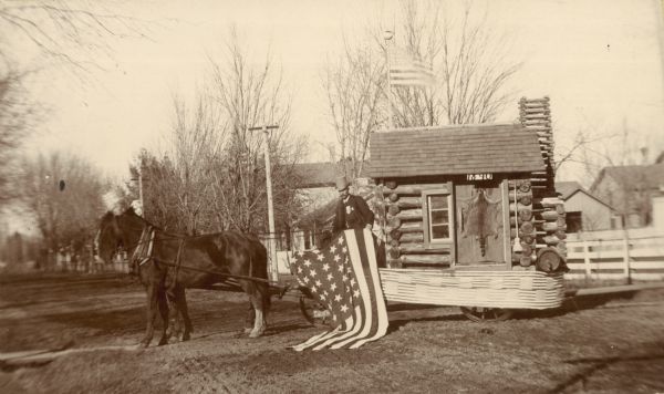Log cabin on trailer pulled by two horses used in the presidential campaign in Wisconsin to promote the candidacy of Benjamin Harrison.