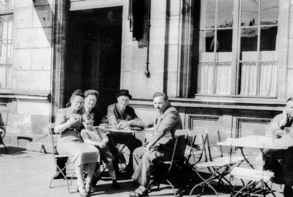 Lucy Rothstein Baras and family at outdoor cafe in Furth, Germany after World War II.  From left: Lucy Rothstein Baras, Victor (son), Edward Baras (husband), Fishel Gelbtuch, Morris Baras (Edward's brother and son-in-law of Fishel Gelbtuch).