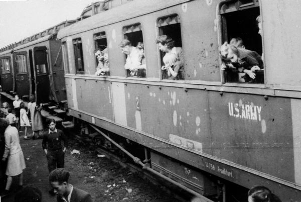 Train full of Polish refugees. Photograph taken by Louis Koplin during the time he worked for the American Jewish Joint Distribution Committee; near the German border. "U.S. Army" is painted on the railroad car.