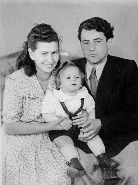 Portrait of Holocaust survivor, Israel Wolnerman, his wife Irene, and their child. Wolnerman was among thousands of prisoners from Staltach (a subsidiary of Dachau) on their way to annihilation in the Austrian Tirol when the train was bombed by the Allies; the prisoners were then liberated by the U.S. Army. The Wolnermans settled in Milwaukee in 1953.