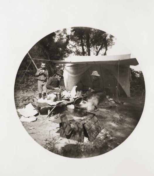 Ten-year-old Fredrik, Jessie's brother William Daniel Turvill,and Reuben Gold Thwaites, have a meal at a campsite at Crooked Creek.