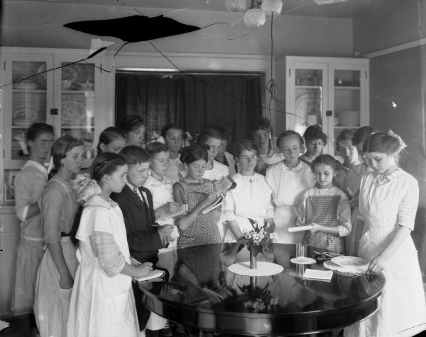 A class of girls learn how to set a table in domestic science class at the University of Wisconsin-Madison.
