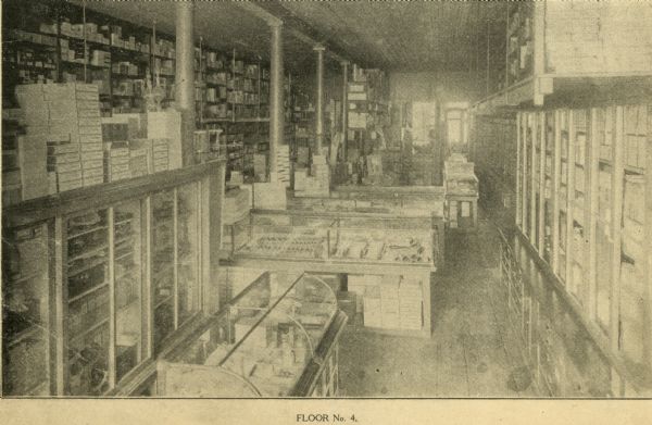 Interior of (Floor No. 4) The F. Dohmen Company Wholesale Druggists.  A salesman's catalog with removable screwed bindings and pages of note paper bound between catalog pages . (One of 13 halftones of the company's exterior and interior images included in catalog.)