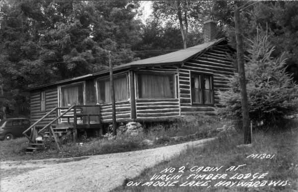 Exterior view of the log cabin. Caption reads: "No 2 Cabin at Virgin Timber Lodge on Moose Lake, Hayward, Wis."