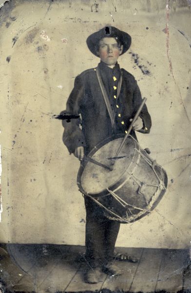 Tintype of Alfred H. Lathrop in his Civil War uniform carrying a drum over his shoulder. Lathrop was a drummer boy.