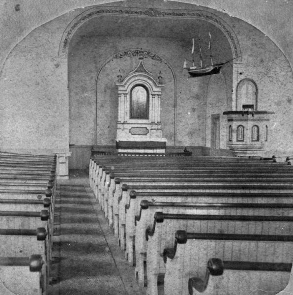 Interior of the Rock Prairie Lutheran Church in Luther Valley. Note the model of the sailing ship hanging from the ceiling of the nave, a traditional practice among seafaring Scandinavians.