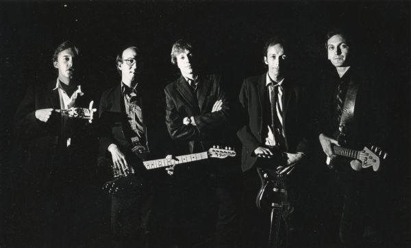 Promotional photograph of the band <i>Spooner</i>. From left: Butch Vig holding a Miller Beer bottle, Dave Benton with a guitar, Jeff Waler, Doug Erickson with a guitar, and Joel Tappero with a bass guitar.