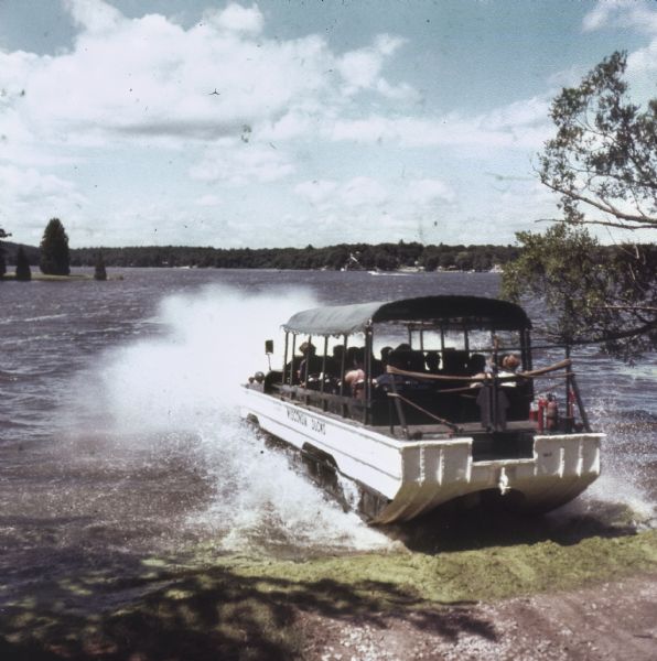 Amphibious vehicle known as a Duck splashes into Lake Delton as it carries passengers on a tour of the Wisconsin Dells.