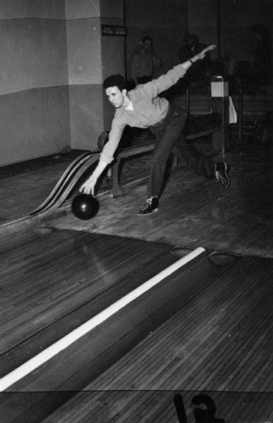 A member of the Local 75 men's bowling team releases the ball down the alley.