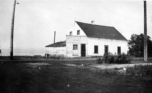 The house of Captain Angus on the shore of Lake Superior in La Pointe on Madeline Island sometime around 1900. The Angus family came to Madeline Island in 1835. The house was one of the oldest houses on Madeline Island.