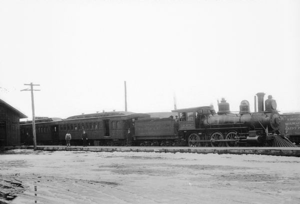 Several men are posing with train No. 5, engine No. 8.