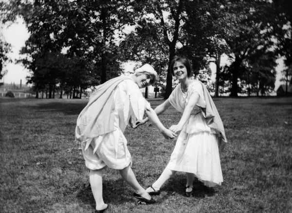 Two costumed dancers on the lawn at Rockford College.