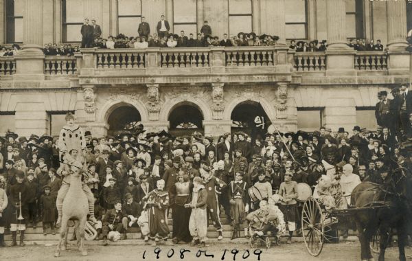 Circus performers posed in front of the Wisconsin Historical Society, then known as the State Historical Society of Wisconsin.