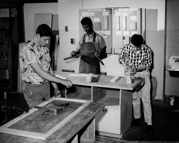 Three students work in the shop for a cabinetmaking class at Milwaukee Vocational and Adult Schools.