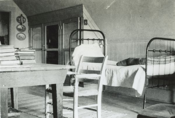 Interior of Cecil W. Smith's room at Hillside home school showing the bedroom area.