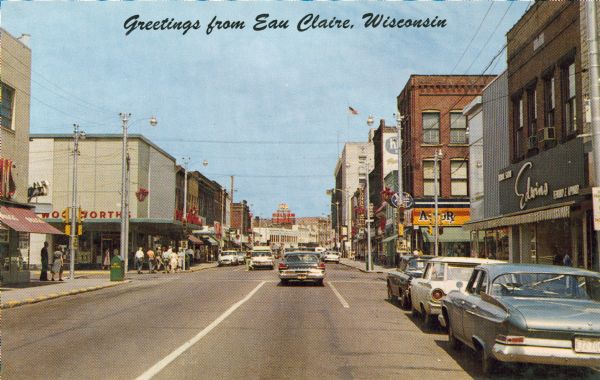 View down street of the downtown business district, including Woolworth's (left side) and Actor's Rexall Drug Store (right side). Caption reads: "Greetings from Eau Claire, Wisconsin."