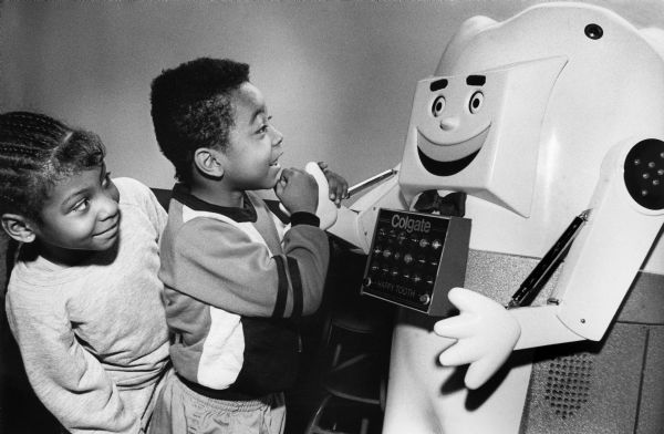 Children meet "Happy Tooth", a robot sponsored by Colgate toothpaste on a 30-state tour to promote dental hygiene to young school children.