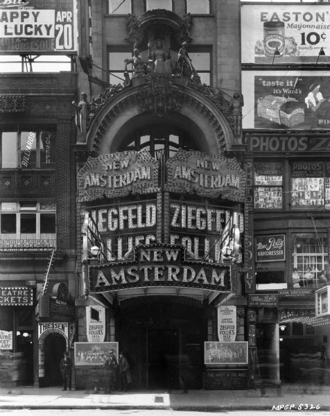 Front view of the New Amsterdam Theatre (Theater), which advertises the 1925 Ziegfield Follies on its marquee and on street level the play "The Knife in the Wall."