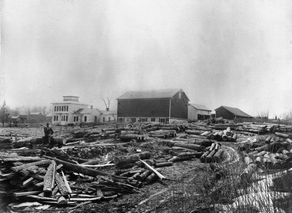 A view of Rudolph Herrling's sawmill and log yard in front of the Herling farm.